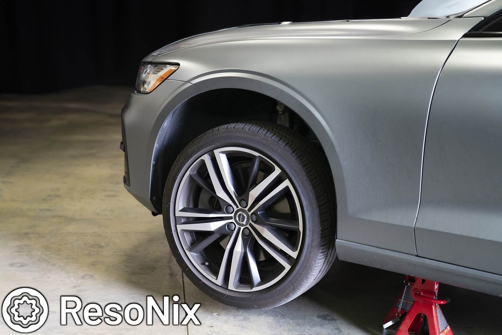 Removing front tire from a jacked up car in preparation of sound proofing the wheel wells