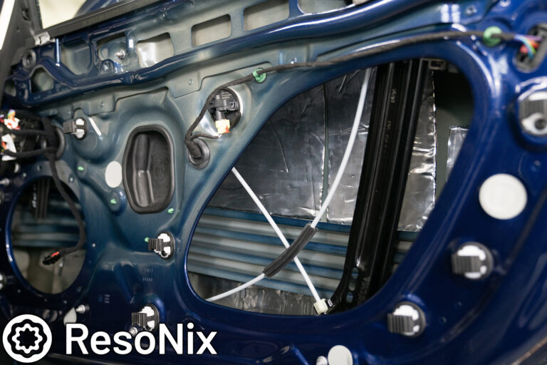 ResoNix Sound Solutions Mega CLD Squares sound deadening material installed into the door of a Porsche 911 to reduce distortion from the audio system and reduce resonance, outside wind noise, and tire noise