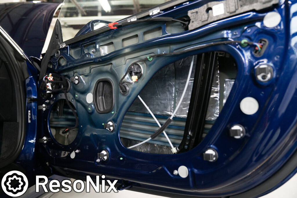 ResoNix Sound Solutions Mega CLD Squares sound deadening material installed into the door of a Porsche 911 to reduce distortion from the audio system and reduce resonance, outside wind noise, and tire noise